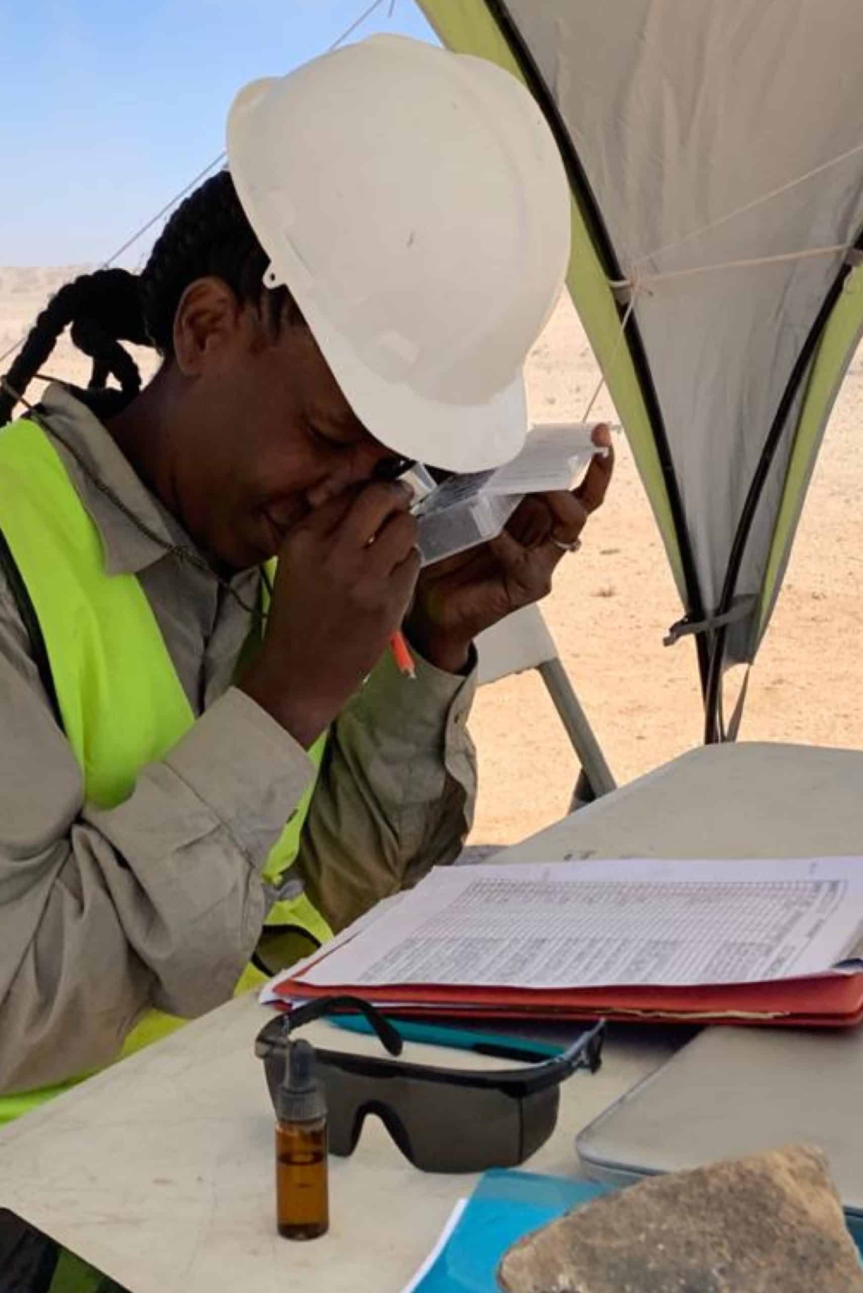 Woman inspecting a sample at Eureka project E-TECH RESOURCES