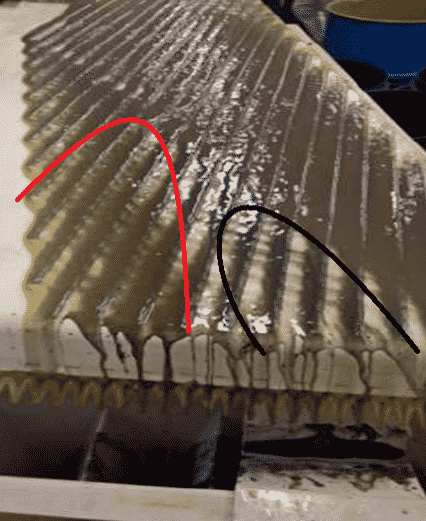 Shaking table in action. Note the black minerals on the right-hand side (magnetite) disassociating from the lighter brown minerals (monazite) on the left-hand side. Image from gravity test work on Eureka REE Carbonatite, Namibia.