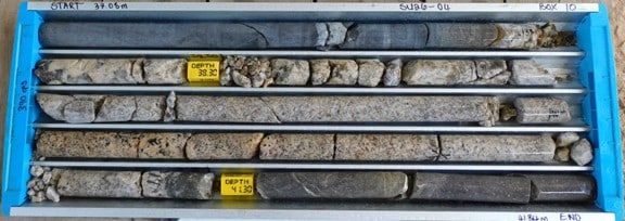 Coarse-grained pegmatitic leucogranite in contact with calc-silicates.